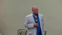 Tracy Parsons speaking at a conference session on the Community Coalition