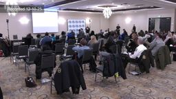 Wide shot of coalition meeting attendees from back of room. 