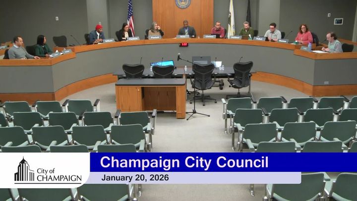 Wide shot of Council Dias at Champaign City Building. Eight Council Members present. 